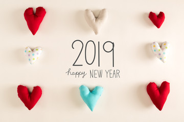 Happy New Year 2019 message with blue heart cushions on a white paper background