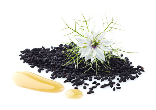 Black cumin oil with seeds and flower