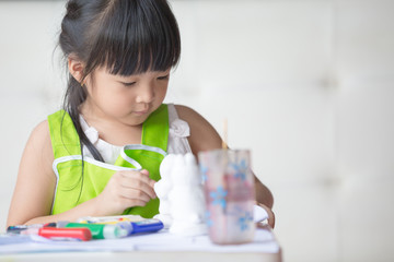 Asian girl painted on plaster doll