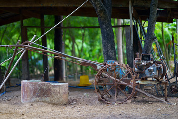 Rusty farm tractor for plow soil before growth rice