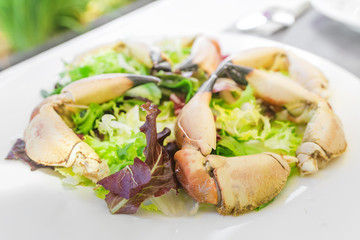 Boiled crab claws on a plate in seafood restaurant