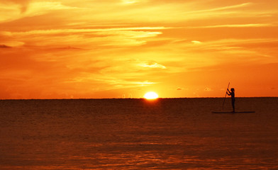 Paddleboarder at sunset