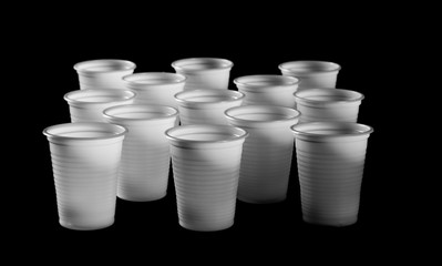 white plastic cups isolated on black background, clipping path