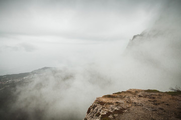 Foggy mountain landscape, rocky edge