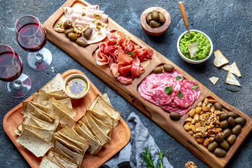 Obraz premium Antipasto Platter. Ham serrano, salami olive jamon dip sauces and red wine