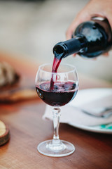 Close Up of Hand Pouring Wine