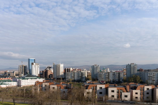 View of the central district of the city of Krasnoyarsk from the hill in the spring afternoon. Krasnoyarsk Region. Russia.