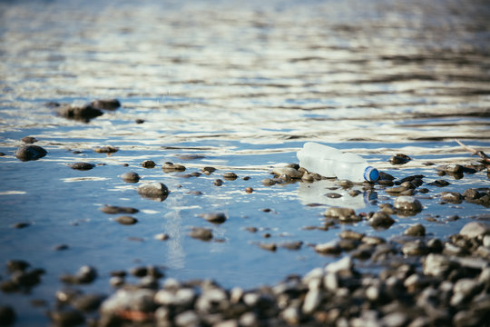 Environmental pollution: plastic bottle on the beach