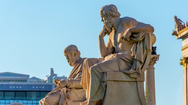 Zoom out of the statues of the Greek philosophers Socrates & Plato