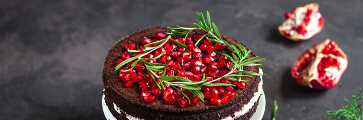 cake with pomegranate and rosemary (chocolate cake). top view.