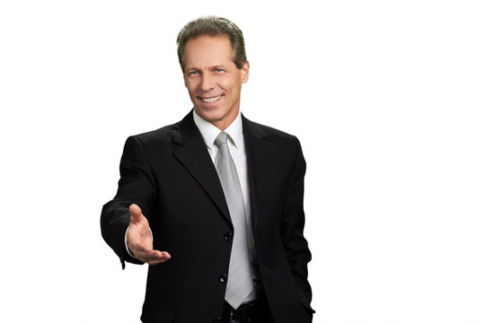 Businessman outstretched hand for greeting. Portrait of businessman extending hand for handshake, isolated on white background.