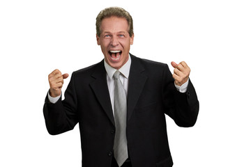 Ecstatic male executive with raised fists. Portrait of excited man in formal wear clenching fists over white background. Business triumph concept.