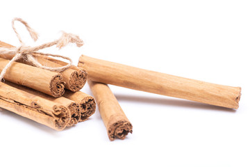 Cinnamon sticks tied with jute rope isolated on white background