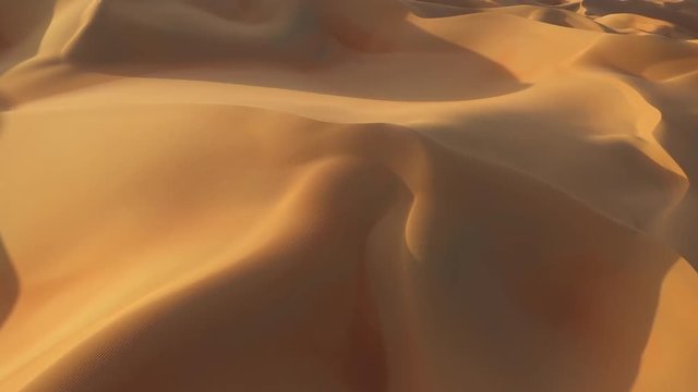 Aerial drone view of massive yellow and gold sand dunes with shadows in empty quarter during sunset. Abu Dhabi, UAE.