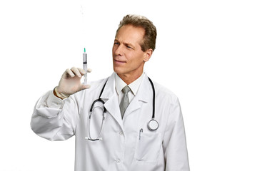 Portrait of male doctor with syringe. Caucasian mature doctor holding syringe isolated on white background. People, professions, healthcare.