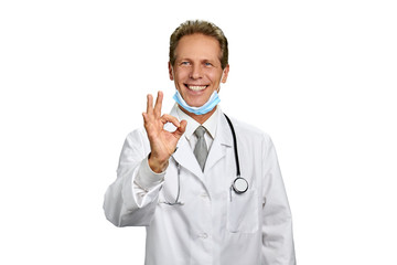 Fototapeta premium Medical specialist showing excellent gesture. Portrait of smiling surgeon giving okay sign isolated on white background. Treatment and ambulance service concept.