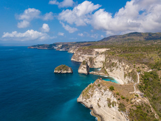Sea coast view with little house standing on the high cliff bring above sea and little rocky islets. Atuh beach, Nusa Penida island. Popular travel destination on Bali holidays. Indonesian background.