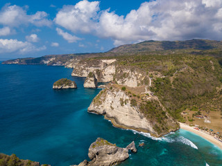 Sea coast view with little house standing on the high cliff bring above sea and little rocky islets. Atuh beach, Nusa Penida island. Popular travel destination on Bali holidays. Indonesian background.