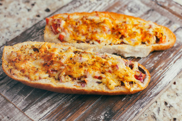 French baguette sandwich with assorted filling. Dish on wooden table. Set of bruschetta.