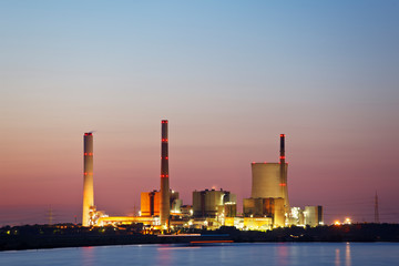 Distant Power Plant At Sunset