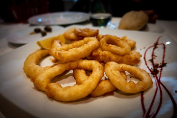 Fried Squid Rings or Calamares a la Romana in a white plate.