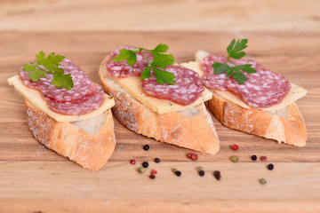 Sandwich with sausage and cheese. Breakfast on the table.