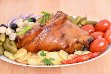German kitchen. Pork leg. Meat dish with vegetables.