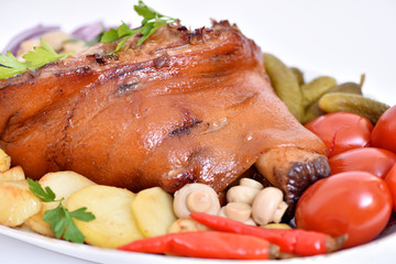 German kitchen. Pork leg. Meat dish with vegetables.