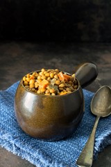 A bowl of lentil stew on a dark background with copy space for your text
