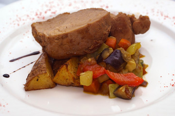 Hot meat portion of the dish. Food fillet with garnish on a plate.
