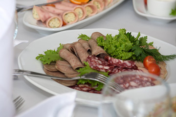 Cold dishes and snacks on the festive table. A rich luxurious meal in the restaurant. 