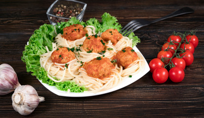 vermicelli with cutlets on a wooden background