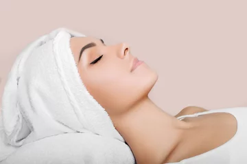 Keuken spatwand met foto woman with clean fresh face, with towel on head, relaxing after spa receiving treatment. Women with perfect skin enjoying a skin care treatment © Peakstock