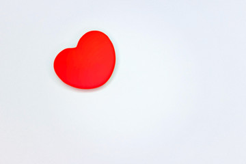 Red heart on white background, background and texture.