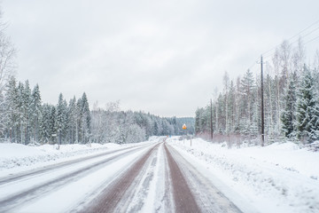 Obraz premium Car with lights on a snow covered road.