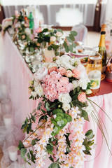 festive table for the bride and groom decorated with cloth and flowers