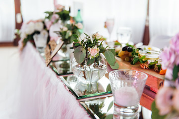 festive table for the bride and groom decorated with cloth and flowers