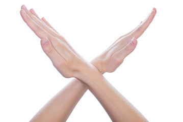 Close up studio photo of woman's hand holding making showing demonstrating giving x signal isolated...