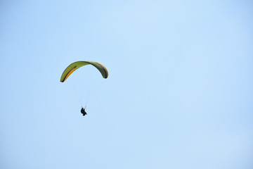 Paraglider on a clear day for background usage. Spaces for type.