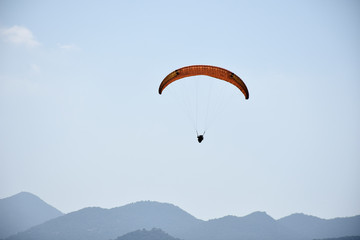 Paraglider on a clear day for background usage. Spaces for type.