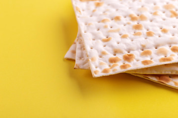 Traditional Jewish kosher matzo on bright yellow background