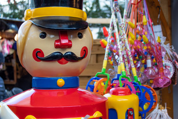 Naklejka premium Nutcracker statue next to candy on Christmas Market