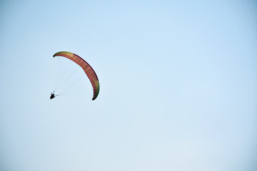 Paraglider on a clear day for background usage. Spaces for type.