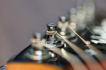guitar  with wooden brown neck and strings, close up blurry background, texture, abstract