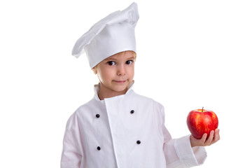 Chef girl in a cap cook uniform, holding the red apple. Looking at the camera. Human emotions, facial expression feeling, attitude