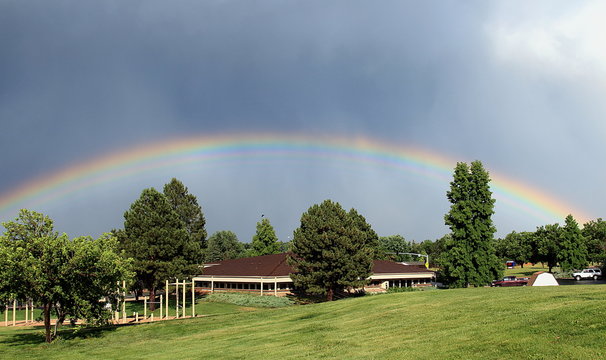 Rare And Bizarre Rainbow Over The Trees And Fair Station In Aurora Neighborhood Near Denver, Colorado