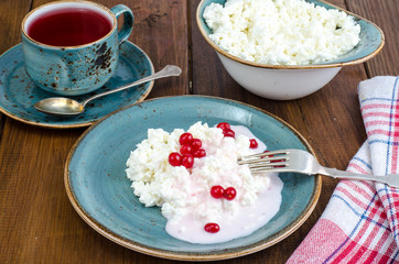 Homemade fresh cottage cheese with yogurt and red berries, tea