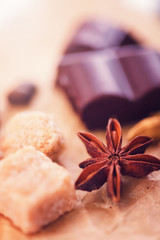 Macro shot of badian with chocolate, brown sugar and coffee beans.