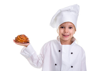 Happy chef girl in a cap cook uniform, holding the bun in the right hand. Looking at the camera