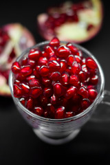 Bright red pomegranate seeds isolated on white background